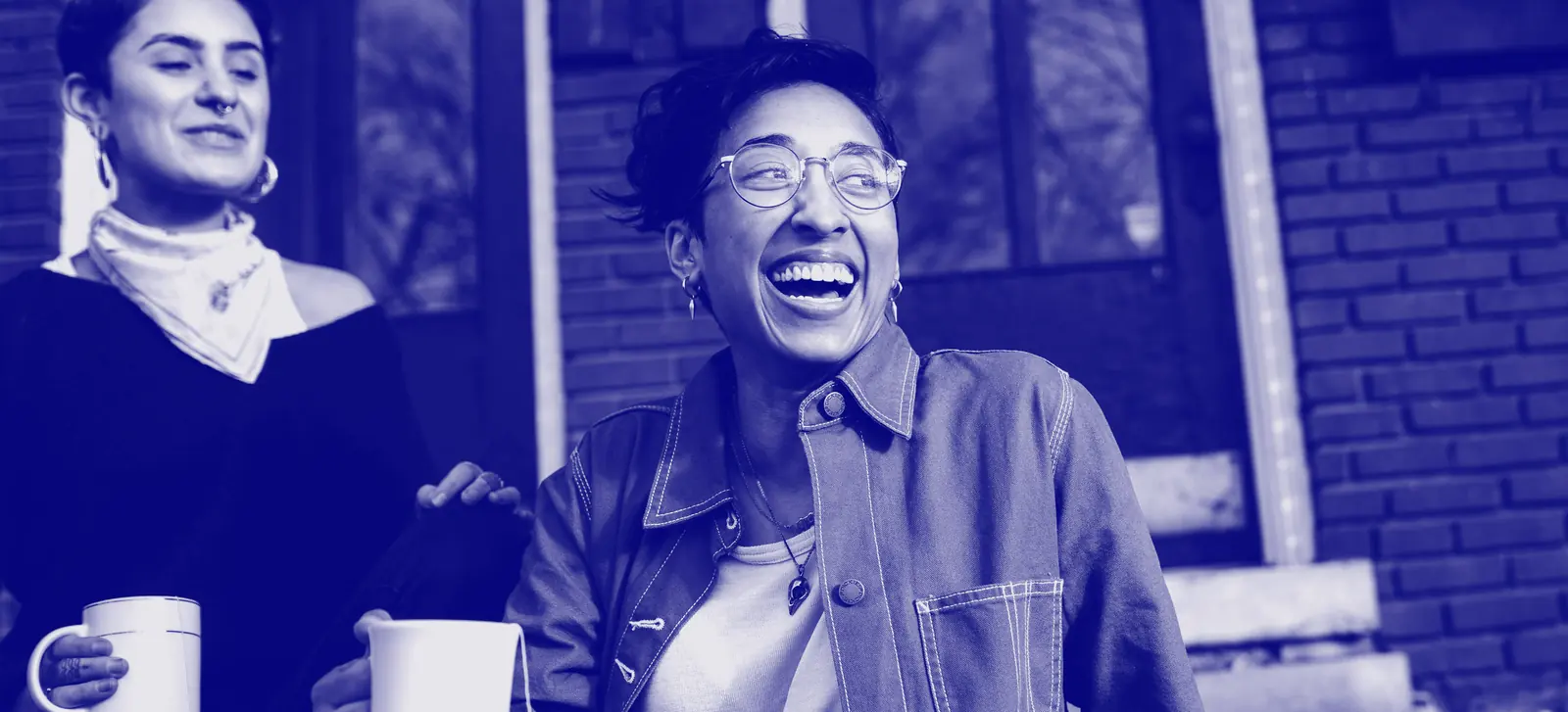Two people laughing during a conversation